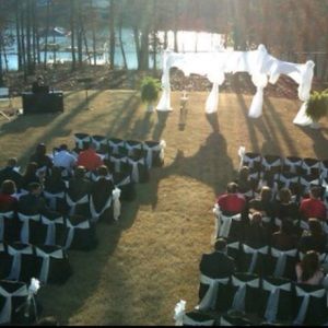 Wedding chair covers in black with white ties.